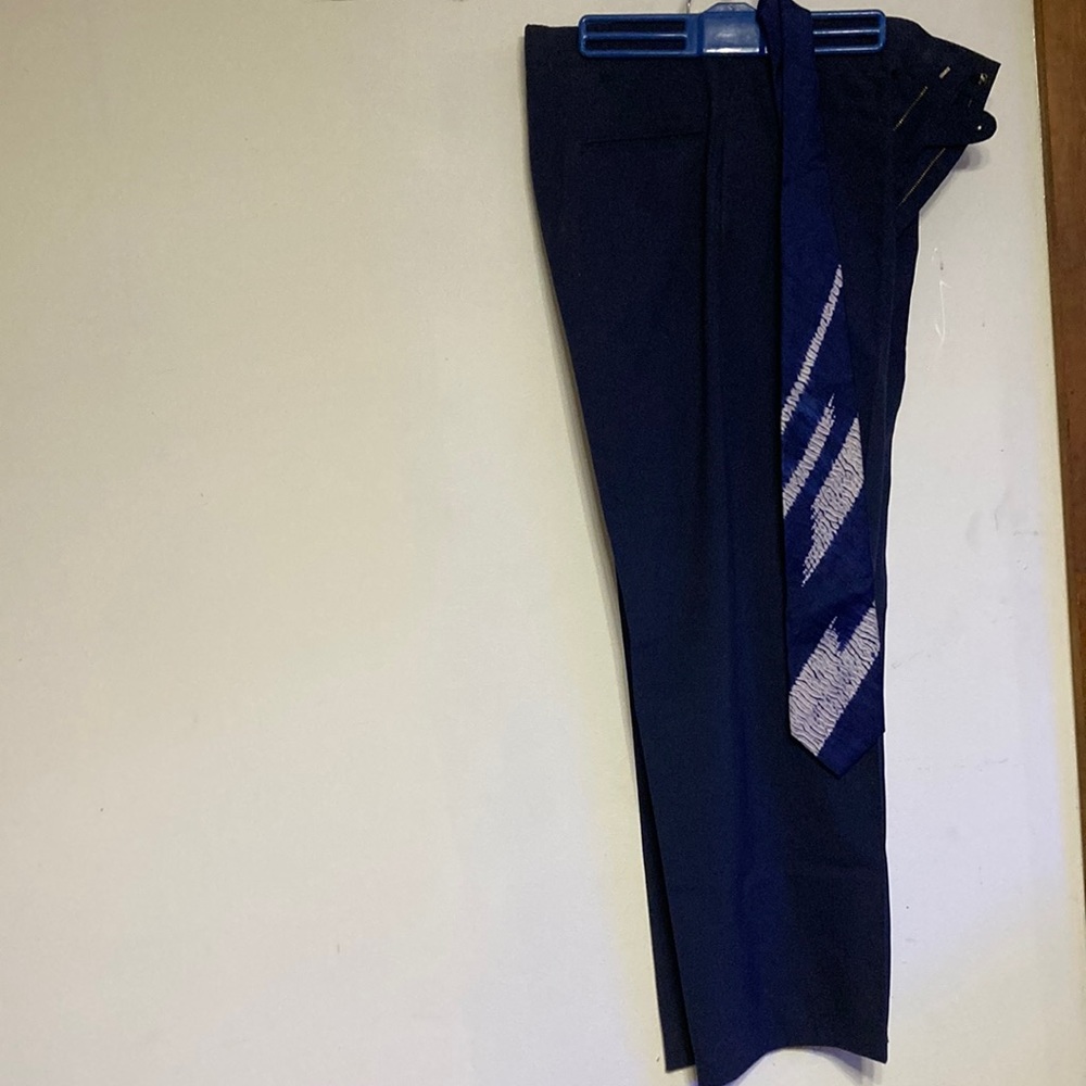 Blue straight legged dress pants with matching blue and gray design Tie